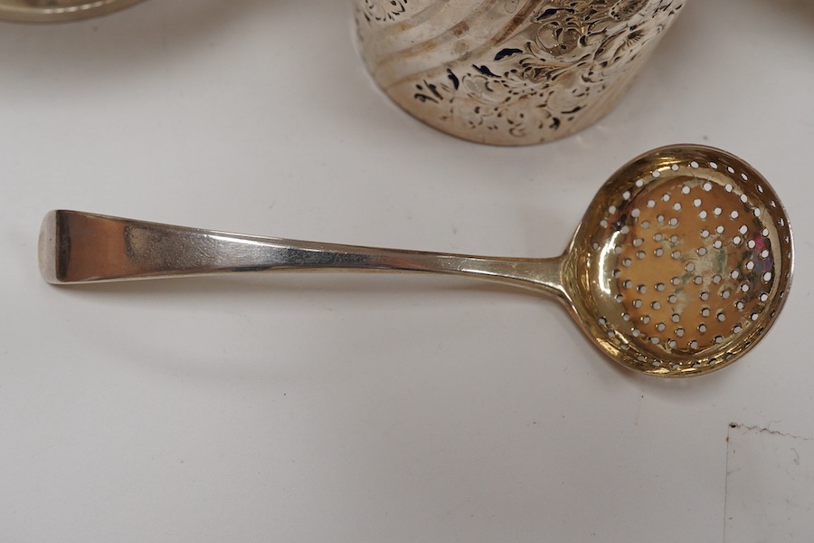 A George III small silver sugar basket, London, 1810, with blue glass liner, 57mm, a George III silver sifter spoon, a pair of silver bonbon dishes and an Edwardian small rose bowl, 16.9oz. Condition - poor to fair to go